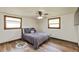 Cozy bedroom with hardwood floors, ceiling fan, and comfortable bed for a relaxing retreat at 1502 N Matthews Rd, Greenwood, IN 46143