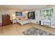 Spacious bedroom with hardwood floors, recessed lights, and ample natural light at 1502 N Matthews Rd, Greenwood, IN 46143