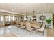 Bright dining area with seating for eight, open layout to living area, and hardwood flooring at 1502 N Matthews Rd, Greenwood, IN 46143
