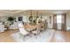 Open concept dining room with a large wooden table, comfortable seating, and modern pendant lighting at 1502 N Matthews Rd, Greenwood, IN 46143
