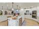 Spacious kitchen features white cabinets, hardwood flooring, and stainless steel appliances at 1502 N Matthews Rd, Greenwood, IN 46143