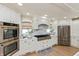 Contemporary kitchen featuring stainless appliances, custom cabinetry and hardwood floors at 1502 N Matthews Rd, Greenwood, IN 46143