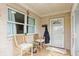 Inviting front porch with seating area, offering a charming welcome to the home at 1502 N Matthews Rd, Greenwood, IN 46143