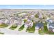 Picturesque aerial view of a suburban neighborhood with a pond and blossoming trees at 15144 Dry Creek Rd, Noblesville, IN 46060