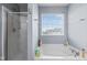 Bright bathroom with a soaking tub, separate shower, and natural light creating a spa-like experience at 15144 Dry Creek Rd, Noblesville, IN 46060