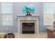 Close-up on a stylish fireplace with a decorative mantel, clock, and turtle artwork above at 15144 Dry Creek Rd, Noblesville, IN 46060