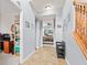 Hallway with tile flooring, gray walls, and an open view to an entertainment room at 15144 Dry Creek Rd, Noblesville, IN 46060