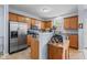 Well-lit kitchen features wooden cabinets, stainless steel appliances, and granite countertops at 15144 Dry Creek Rd, Noblesville, IN 46060