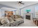 Inviting living room featuring a fireplace, ceiling fan, and open access to kitchen and dining areas at 15144 Dry Creek Rd, Noblesville, IN 46060