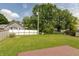 This large backyard is covered in healthy green grass and is surrounded by a white wooden fence at 1579 Winding Creek Trl, Brownsburg, IN 46112