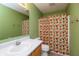 Bathroom with neutral-colored flooring, oak cabinet, and shower/tub combo with orange floral curtain at 1579 Winding Creek Trl, Brownsburg, IN 46112