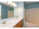 This bathroom is painted a calming blue and has a double sink and shower/tub combo at 1579 Winding Creek Trl, Brownsburg, IN 46112