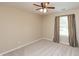 This carpeted bedroom features a ceiling fan, a window with curtains, and neutral paint at 1579 Winding Creek Trl, Brownsburg, IN 46112
