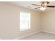 This carpeted bedroom features a ceiling fan, window, and neutral paint at 1579 Winding Creek Trl, Brownsburg, IN 46112
