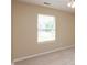 This carpeted bedroom has neutral paint, a ceiling fan, and a large window at 1579 Winding Creek Trl, Brownsburg, IN 46112