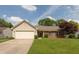 Charming single Gathering home with vinyl siding, brick accents, attached garage, and a well-manicured lawn at 1579 Winding Creek Trl, Brownsburg, IN 46112