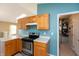 Kitchen featuring stainless steel appliances, oak cabinets, a tile backsplash, and an adjoining pantry area at 1579 Winding Creek Trl, Brownsburg, IN 46112