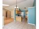 Open kitchen area featuring tile floors, modern appliances, oak cabinets, and a connected living space at 1579 Winding Creek Trl, Brownsburg, IN 46112