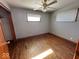 Cozy bedroom features original hardwood flooring, ceiling fan, a window with blinds, and neutral paint at 1618 E 24Th St, Muncie, IN 47302