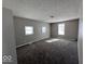 Serene bedroom with three windows and plush carpeting, offering a comfortable retreat at 1619 E 20Th St, Muncie, IN 47302