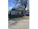 Charming single-story home with a cozy front porch and a well-maintained lawn under a sunny sky at 1619 E 20Th St, Muncie, IN 47302
