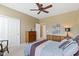 Bedroom featuring neutral paint, wood furniture, and a ceiling fan for added comfort at 16243 Oliver St, Fishers, IN 46037