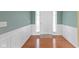 Bright foyer featuring hardwood floors, white trim and a full light door at 16243 Oliver St, Fishers, IN 46037