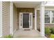 Close-up of the front door with decorative brickwork, white pillars and a welcome mat at 16243 Oliver St, Fishers, IN 46037