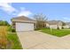 Beautiful single-story home with a two-car garage and a lush green lawn and landscaping at 16243 Oliver St, Fishers, IN 46037