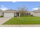 Charming single-story brick home with a well-manicured lawn and attached two-car garage at 16243 Oliver St, Fishers, IN 46037