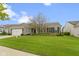Inviting single-story home with a well-kept lawn and a two-car attached garage at 16243 Oliver St, Fishers, IN 46037