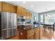 Kitchen with stainless steel refrigerator and eat-in dining area with large windows at 16243 Oliver St, Fishers, IN 46037