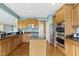 Kitchen featuring stainless steel appliances, granite countertops, and custom cabinetry at 16243 Oliver St, Fishers, IN 46037