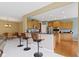 Open-concept kitchen featuring stainless steel appliances, bar seating and wood cabinets at 16243 Oliver St, Fishers, IN 46037