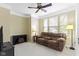 Cozy living room with crown molding, ceiling fan, and comfortable seating area at 16243 Oliver St, Fishers, IN 46037
