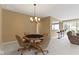 Spacious living room with poker table and open floor plan with adjacent bar seating and living room at 16243 Oliver St, Fishers, IN 46037