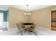 Cozy living room features neutral carpet, elegant chandelier, and poker table for entertaining at 16243 Oliver St, Fishers, IN 46037