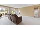 Bright living room featuring neutral walls, carpeted flooring, and sliding glass doors to the outside at 16243 Oliver St, Fishers, IN 46037