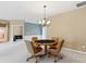 Inviting living room with neutral carpet, and unique lighting fixture over a poker table at 16243 Oliver St, Fishers, IN 46037