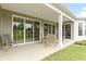 Covered patio featuring neutral toned chairs and table, along with multiple sliding glass doors at 16243 Oliver St, Fishers, IN 46037