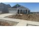 Inviting single-story home featuring a covered front porch, attached garage, and clean concrete driveway at 1644 Winn Ct, Fortville, IN 46040