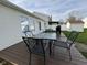 Outdoor deck with glass table and backyard seating area with grill and shed at 1833 Southernwood Ln, Indianapolis, IN 46231