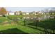 Spacious backyard with a pond view, enhanced by lush greenery and a black chain link fence at 1833 Southernwood Ln, Indianapolis, IN 46231
