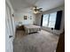 Spacious bedroom with a ceiling fan, large windows with blinds, and neutral carpeting at 1833 Southernwood Ln, Indianapolis, IN 46231