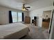 Cozy bedroom with plush carpeting, a ceiling fan, and a window offering natural light at 1833 Southernwood Ln, Indianapolis, IN 46231
