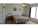 Bright bedroom featuring neutral carpeting, a ceiling fan, and ample lighting at 1833 Southernwood Ln, Indianapolis, IN 46231