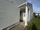 Side entry featuring a covered porch area and vinyl siding, creating a clean, welcoming entrance at 1833 Southernwood Ln, Indianapolis, IN 46231