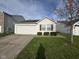 Pleasant home exterior with a manicured lawn and an attached garage, offering curb appeal at 1833 Southernwood Ln, Indianapolis, IN 46231