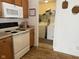 A kitchen with white appliances and access to a laundry room with a washer and dryer at 1833 Southernwood Ln, Indianapolis, IN 46231