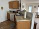 Open kitchen featuring wood cabinets and an island with a view into a cozy living space at 1833 Southernwood Ln, Indianapolis, IN 46231